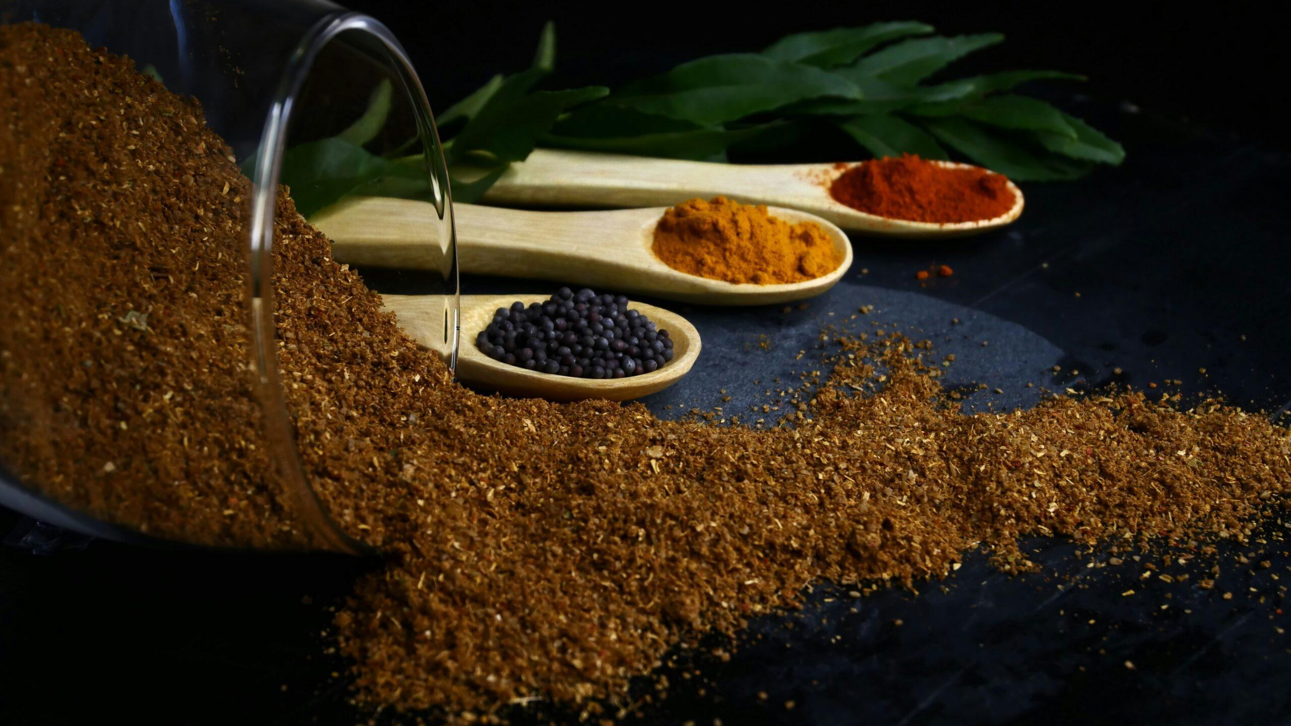 Turmeric root and powder on a wooden table with a warm, natural background